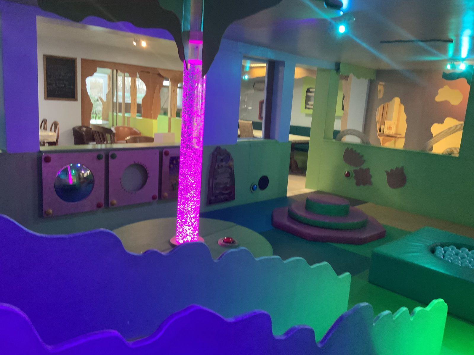 Wide view of the indoor play area with its colour-changing sensory tower